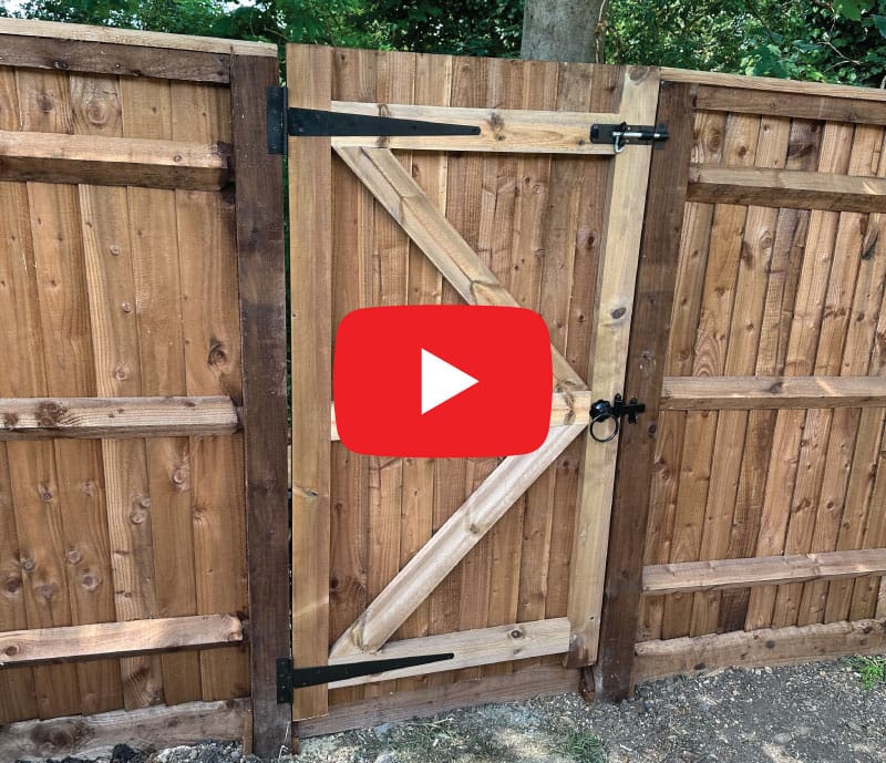 Closeboard garden gate hung on a slope to swing uphill, Berkshire
